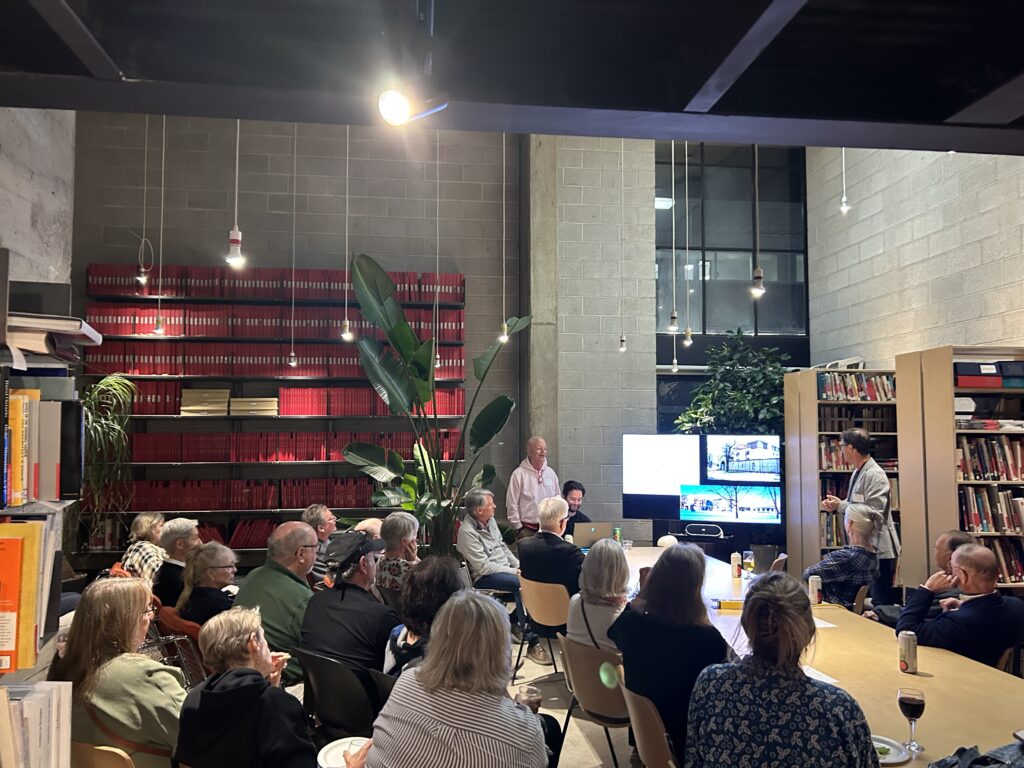 Attendees of the architecture reunion seated listening to a presentation in the architecture building