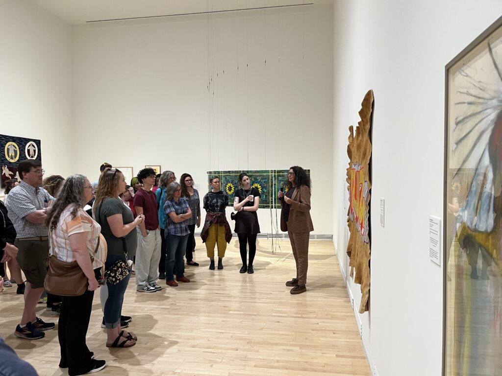 People listening to a speaker while observing the artwork at the Carleton University Art Gallery