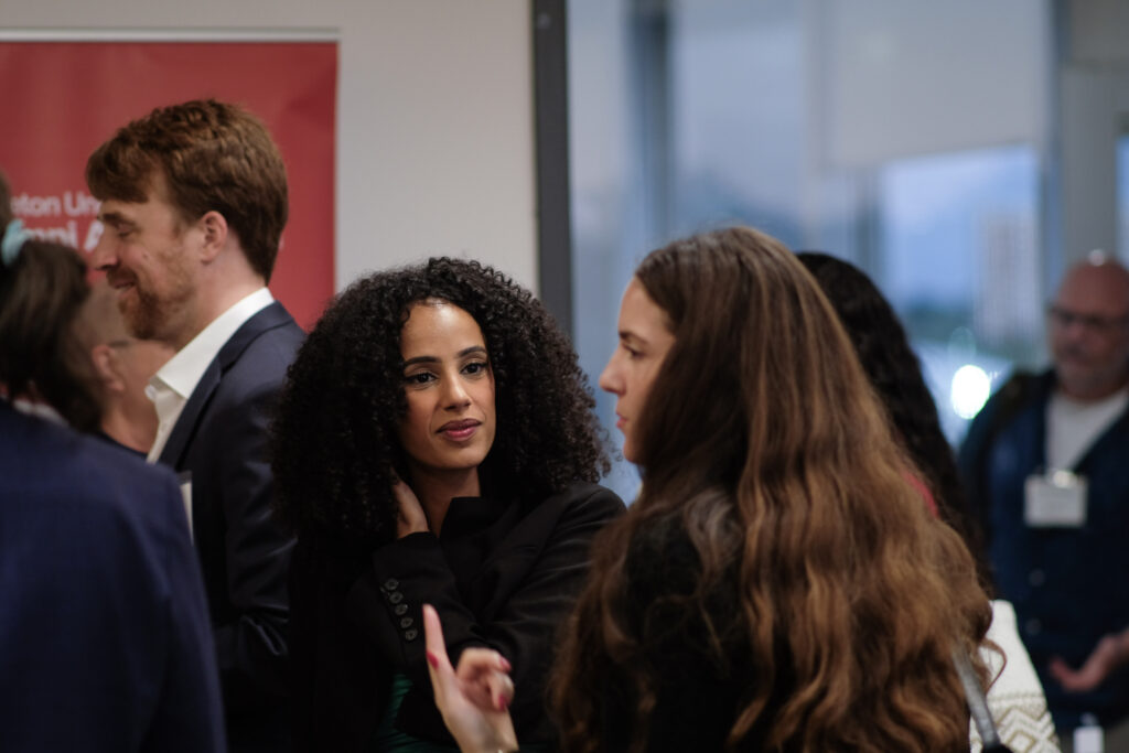Person engaged in conversation at the economics alumni reception