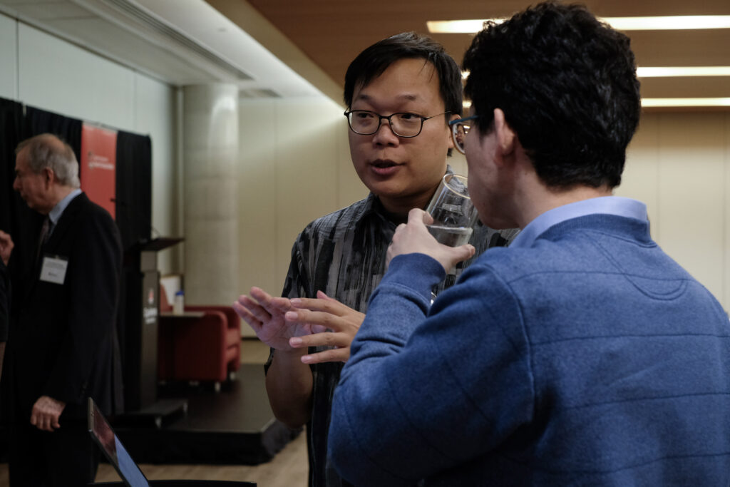 Two people engaged in conversation at the economics alumni reception
