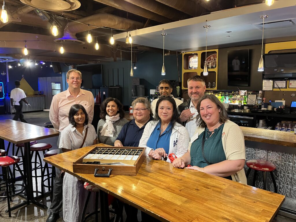 Engineering Class of 2000 smile for a photo in Oliver's Pub