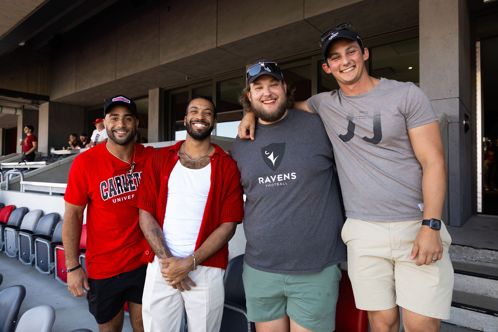 Former Ravens Football players pose for a photo