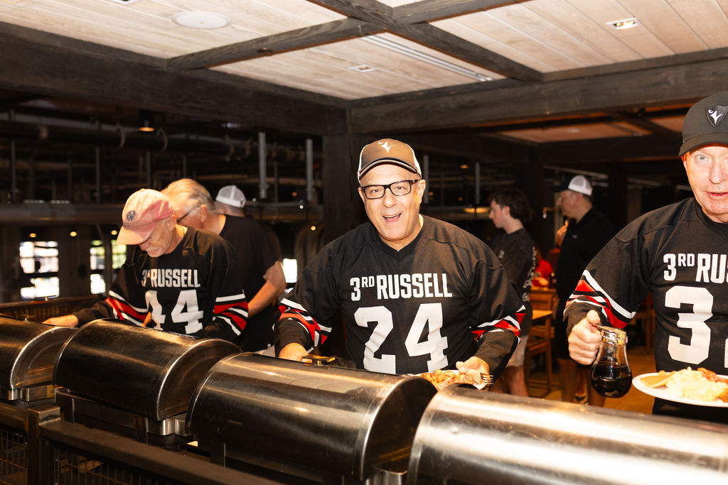 Person smiling while grabbing breakfast from buffet