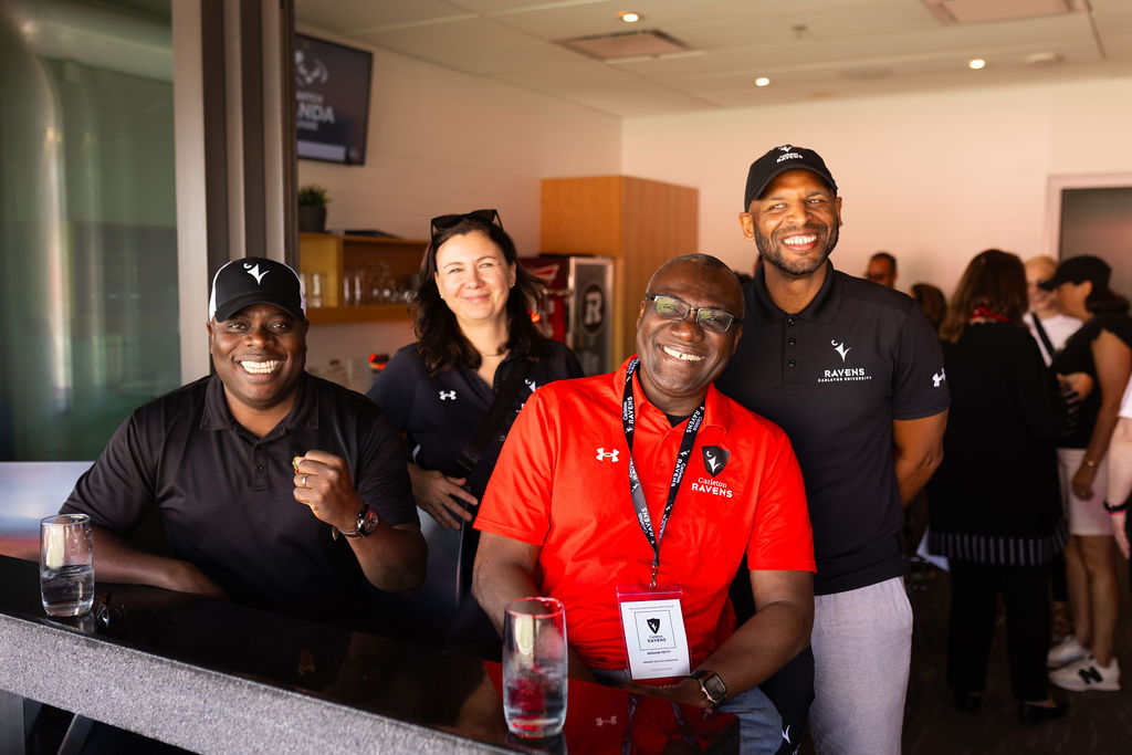 Carleton University President and Vice-Chancellor, Wisdom Tettey smiles with Corrie Hobin, Kwesi Loney