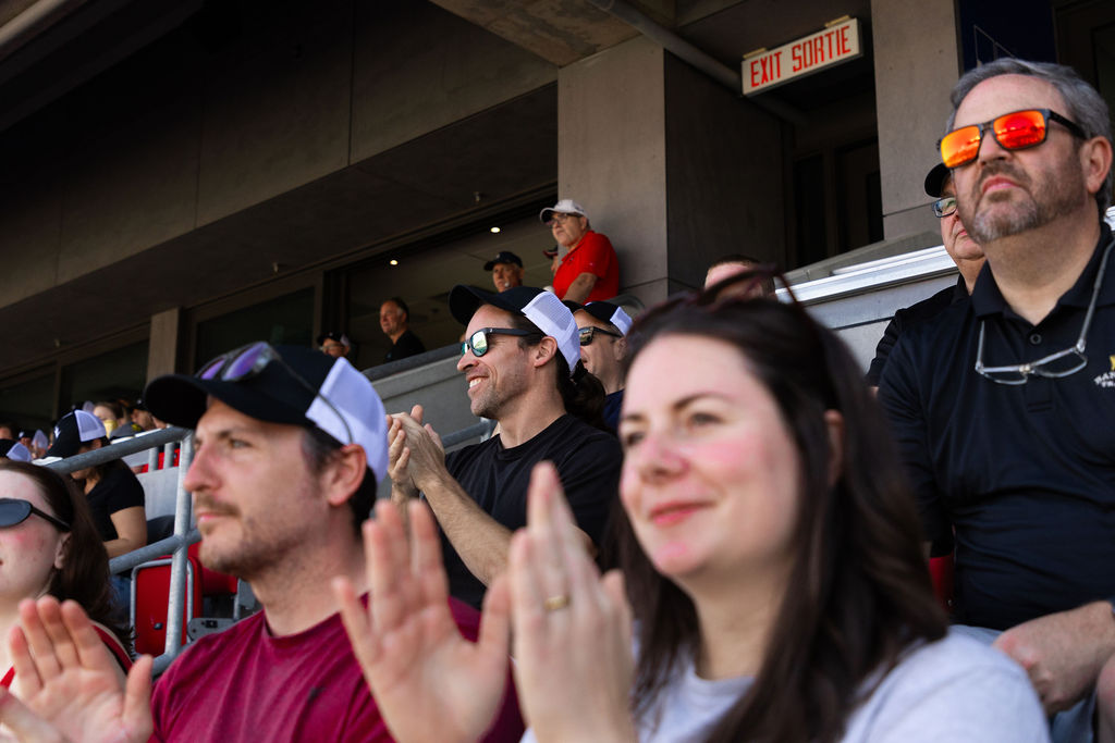 Photo of people watching and cheering at the Panda Game