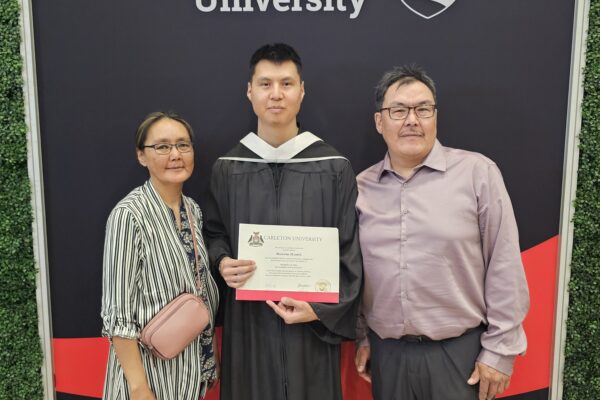 Brenand Mannik with his parents at convocation