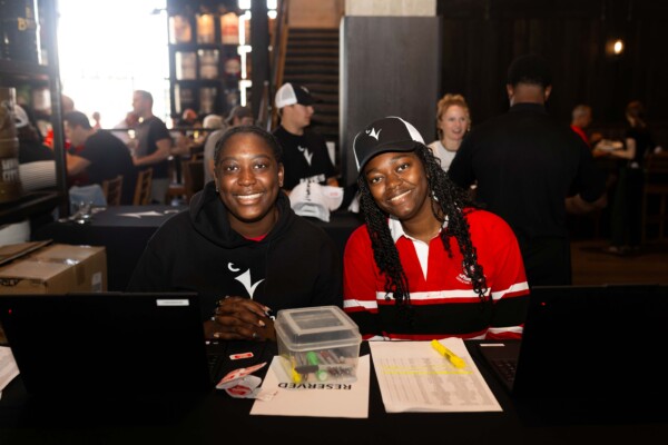 Two people sitting at a registration desk