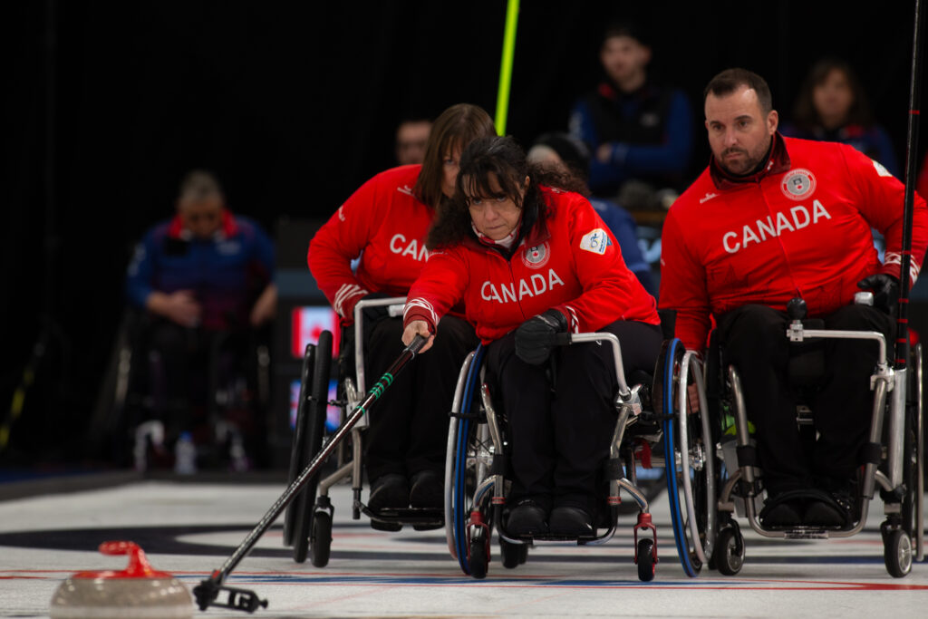 Photo of Collinda Joseph curling. 