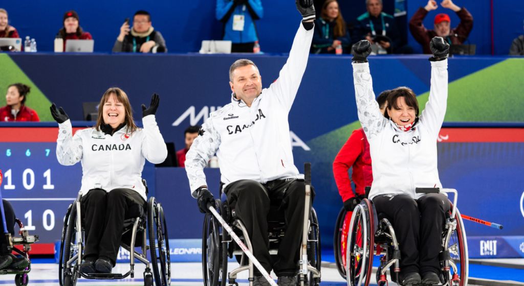Team Canada's wheelchair curling team celebrate after winning their semifinal game against Korea.