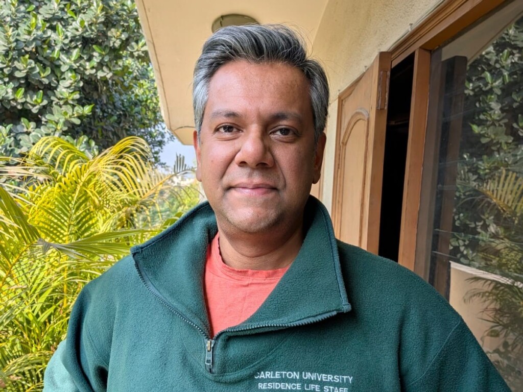 Vishnu Som wearing an official Residence Fellow sweater