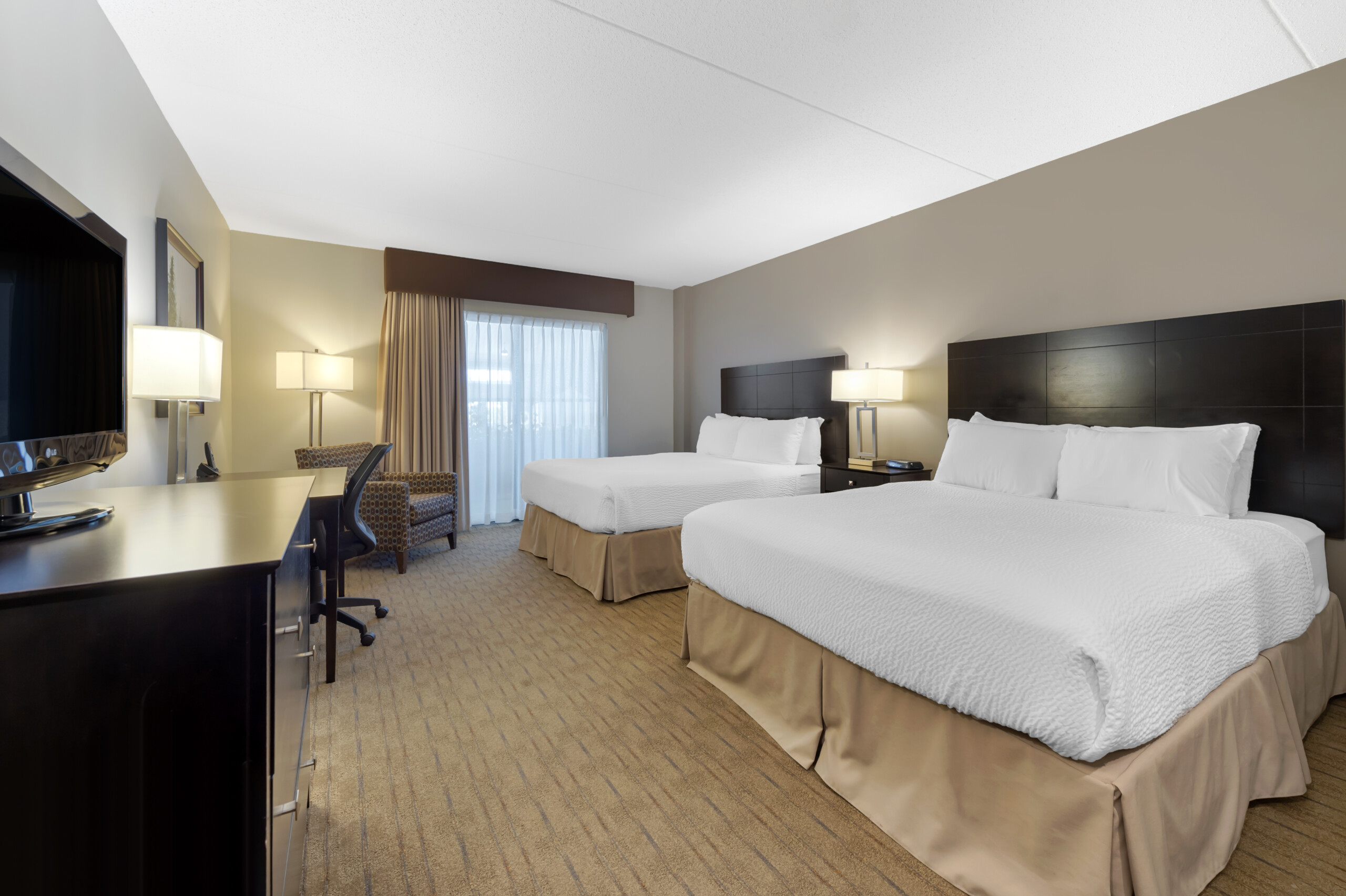 Best Western Pembroke's standard room including two queen beds with white bedspreads.