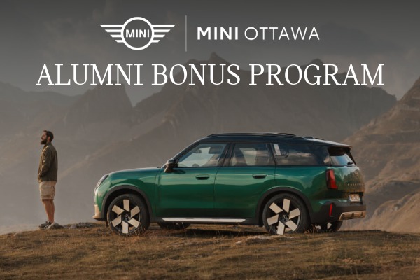 A man stands in front of a dark green MINI Cooper car, contemplating the mountainscape in front of him. Text overlay reads MINI Ottawa Alumni Bonus Program.