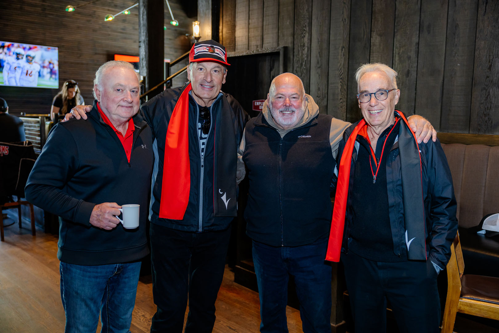 Four people pose for a photo at the Pancaker Breakfast