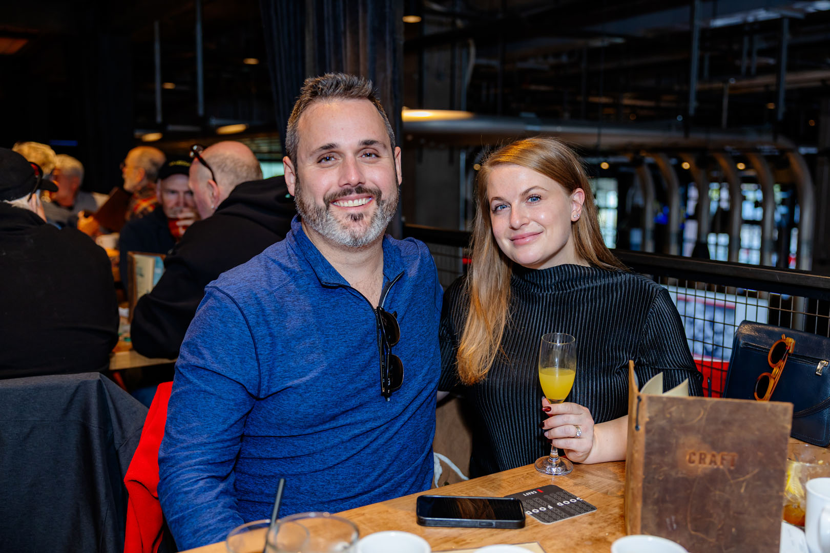 Two people smile, sitting at a table for the Pancaker Breakfast