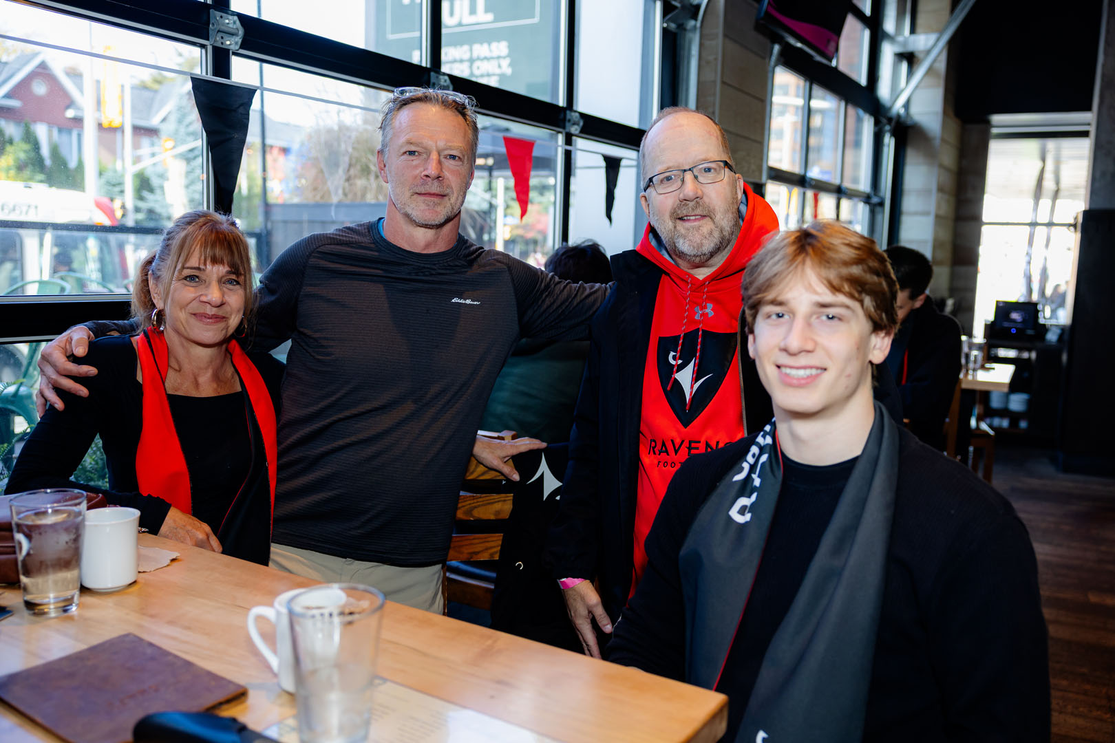 Four people smile in front of a table at the Pancaker breakfast
