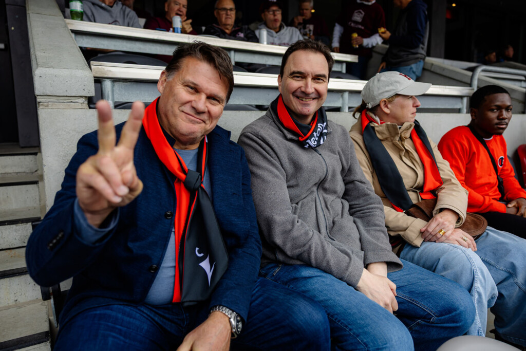 Guests smile for a photo at Panda Game