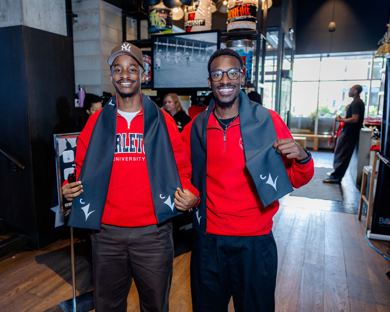 Two guests smile showing their Ravens scarves