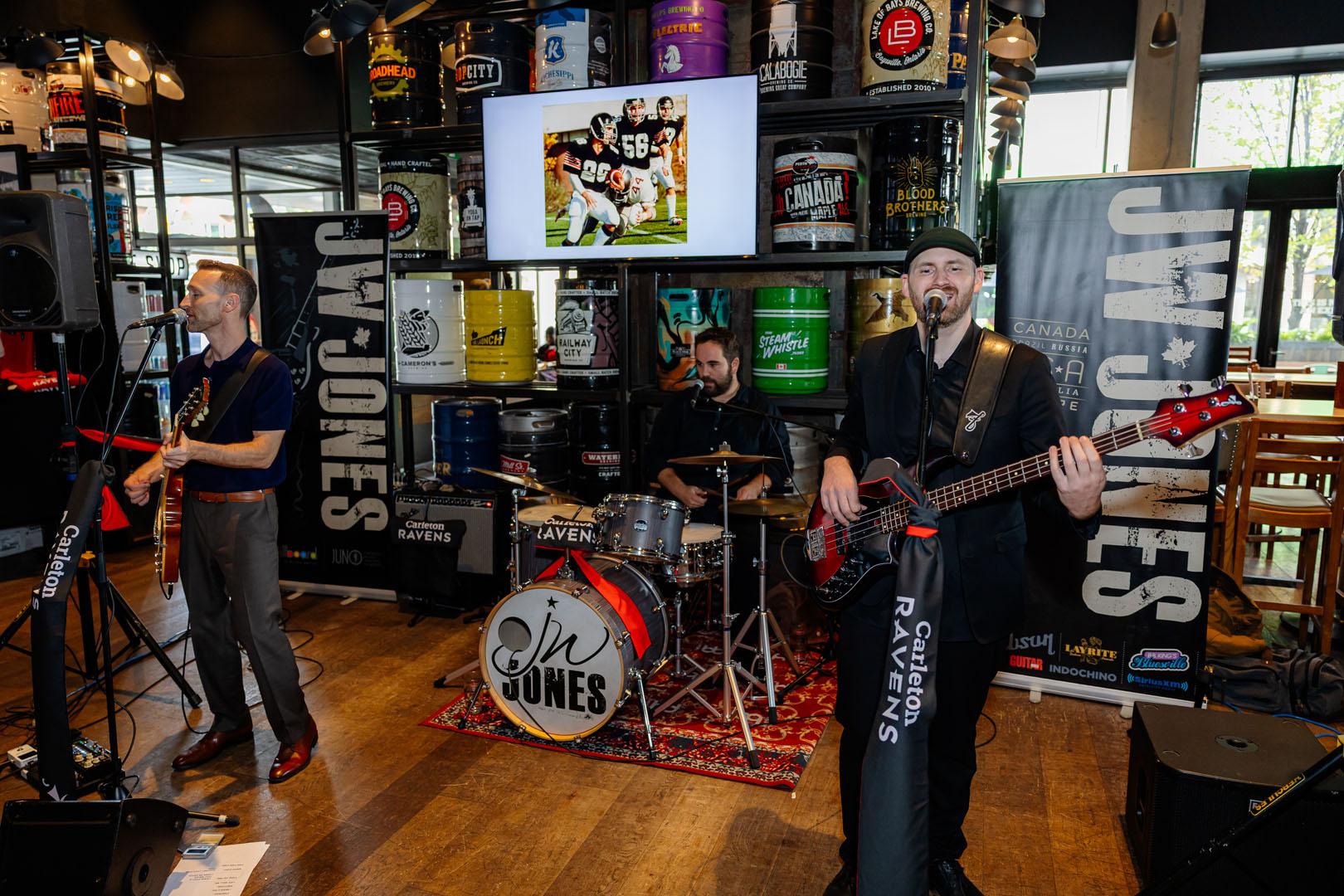 JW Jones performing with football slideshow in the background