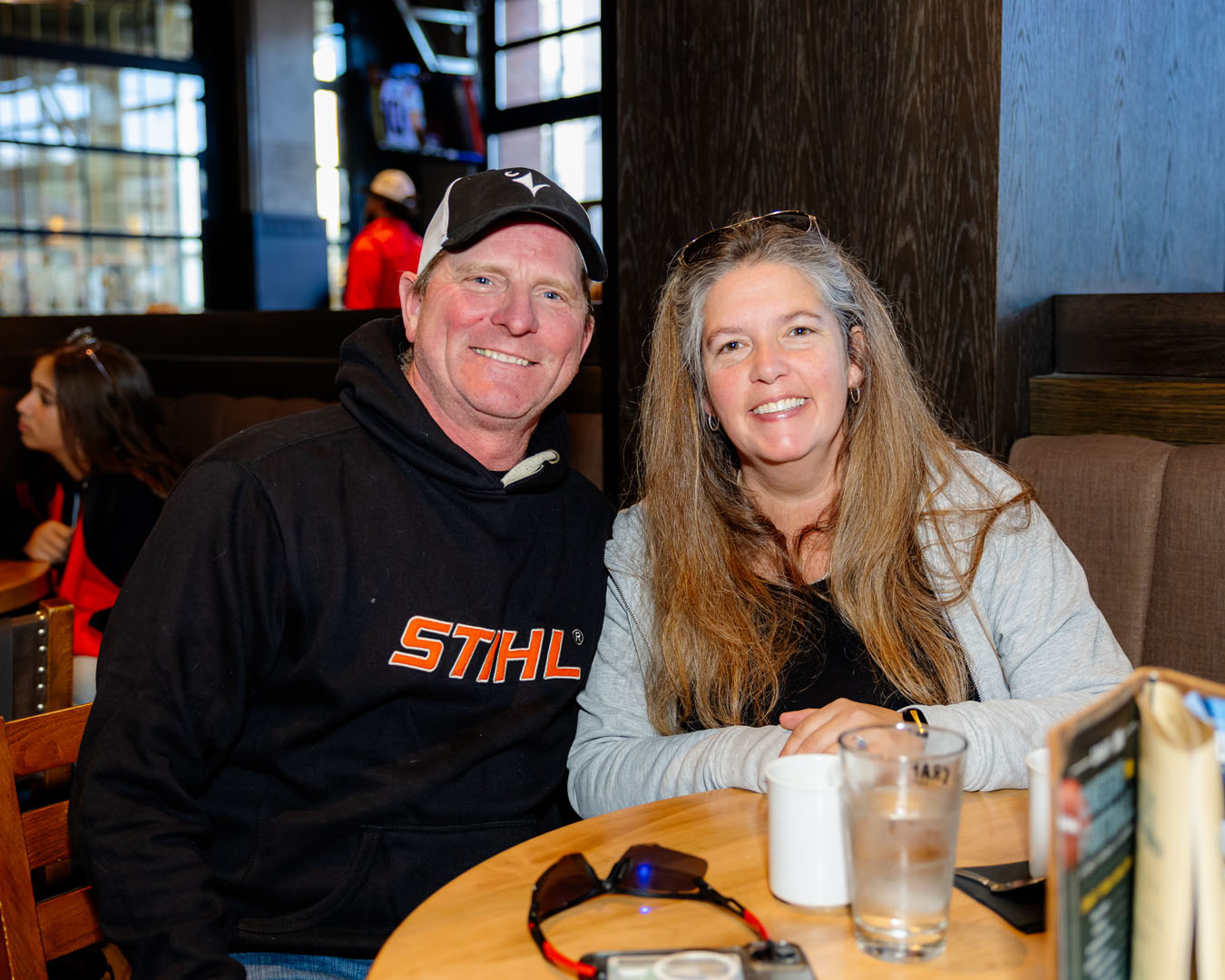 Two people sit smiling at the Pancaker breakfast.