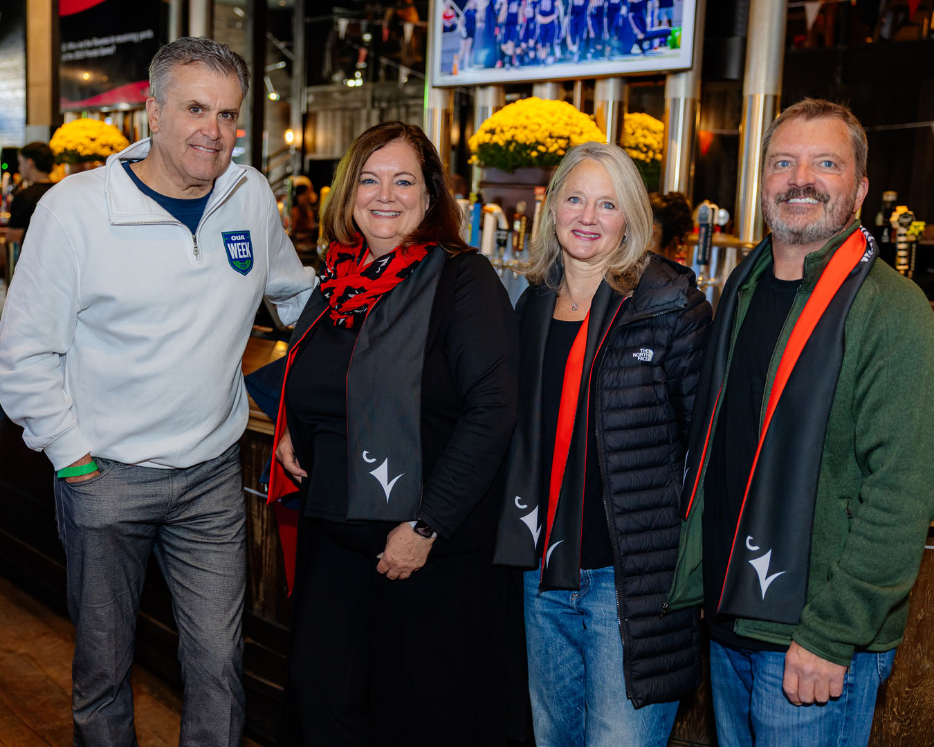 Group of four people smile for a photo at the Pancaker Breakfast