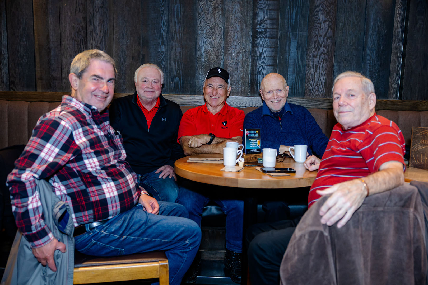 Five people sit around a table at the Pancaker Breakfast