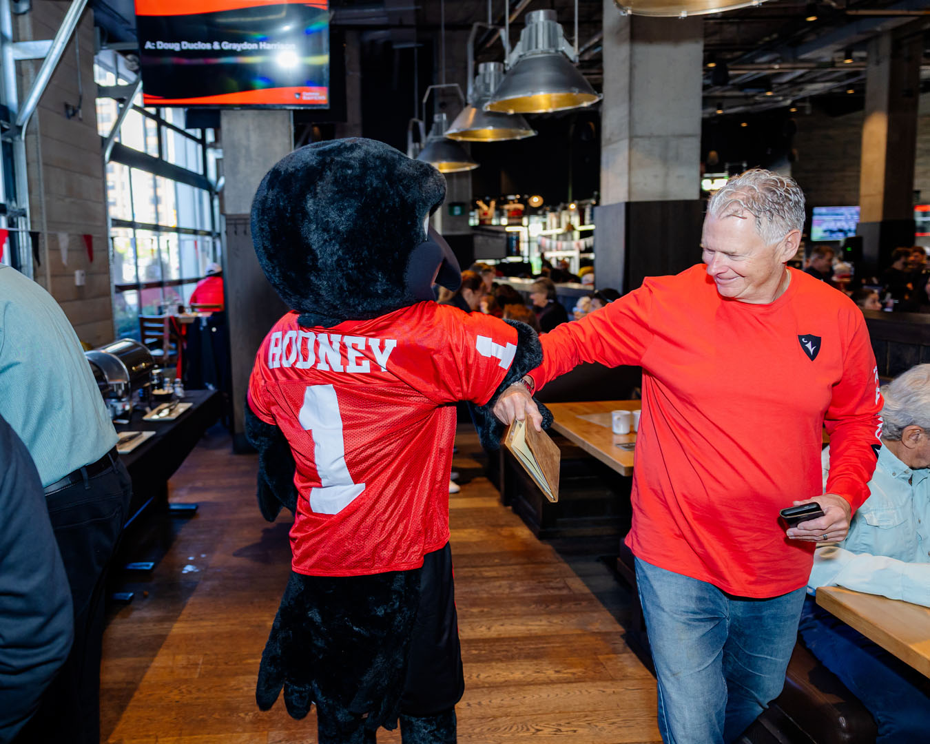 Rodney and a guest high five each other