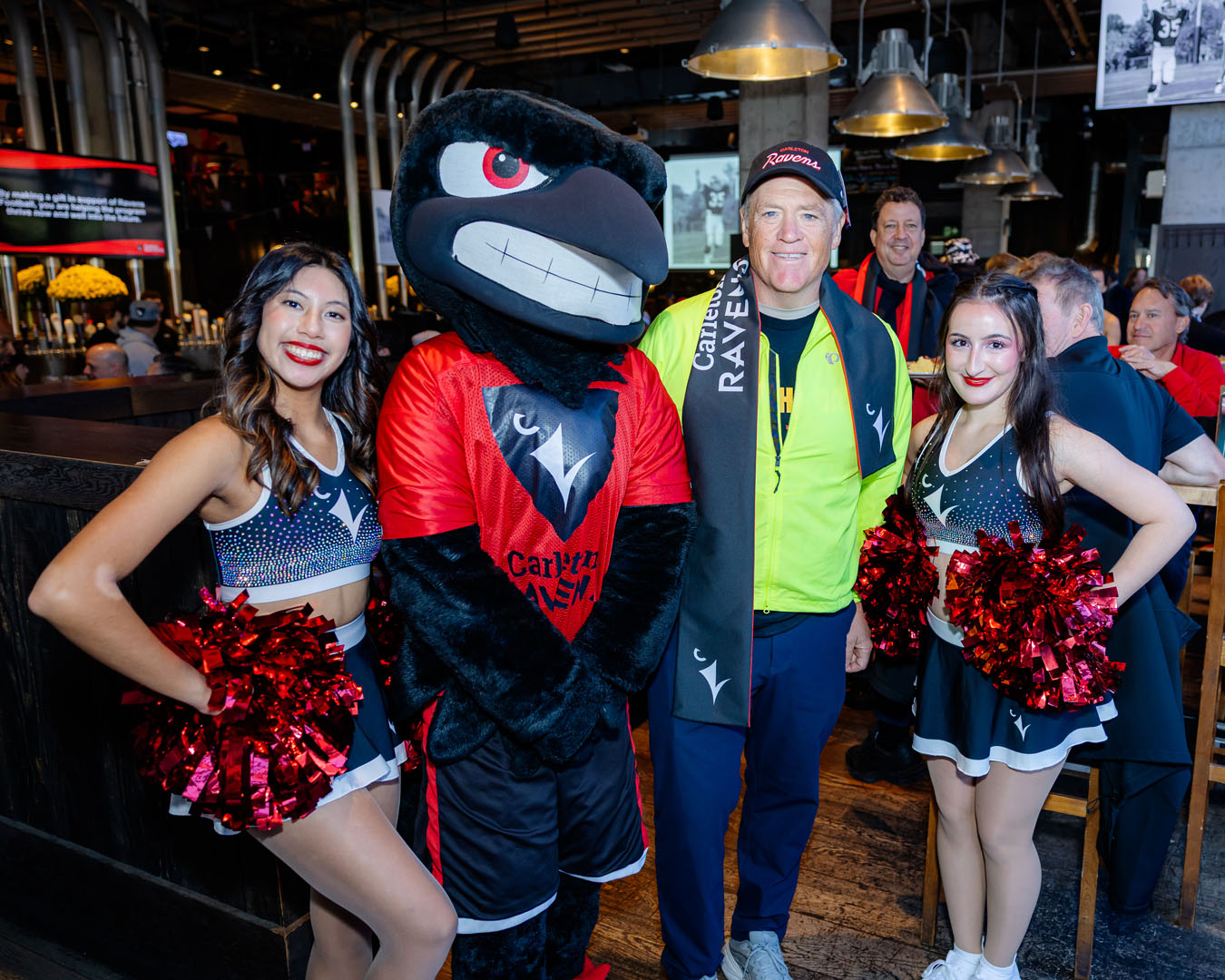 Two members of Ravens Rhythm, Rodney, and a Pancaker Breakfast guest smile for a photo